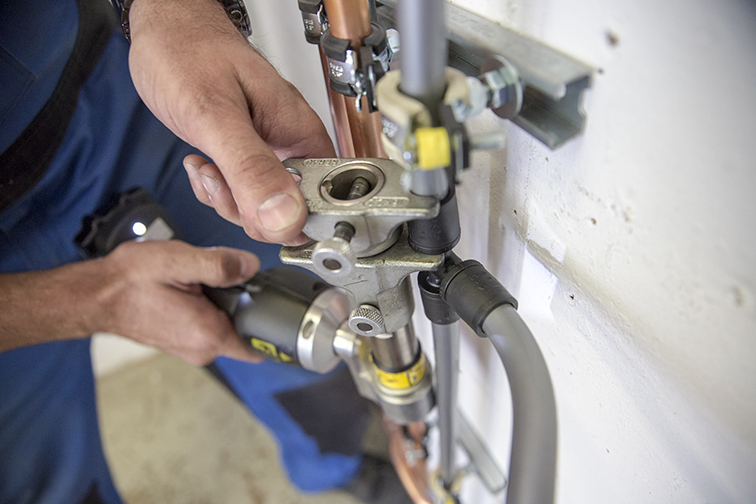 Das Bild zeigt zwei Hände eines Arbeiters, welcher mit einem speziellen Werkszeug Rohrleitungen verpresst. Es handelt sich um eine Arbeitssituation aus dem Gewerk Sanitär, Heizung und Klima. Die Handwerkskammer Chemnitz verfügt in ihren Bildungs- und Technologiezentren über einen Fachbereich SHK und bildet hier Auzubildende und Meister aus. Ebenfalls angeboten werden Weiterqualifizierungen im Bereich SHK.