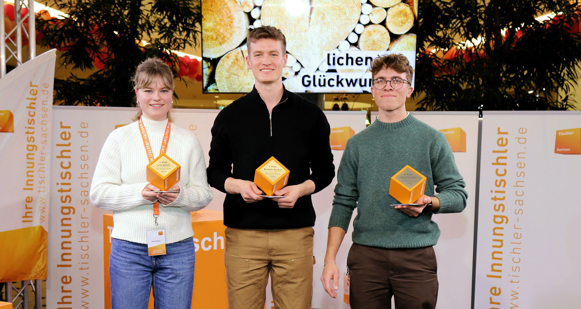 Drei junge Leute mit Auszeichnung in der Hand